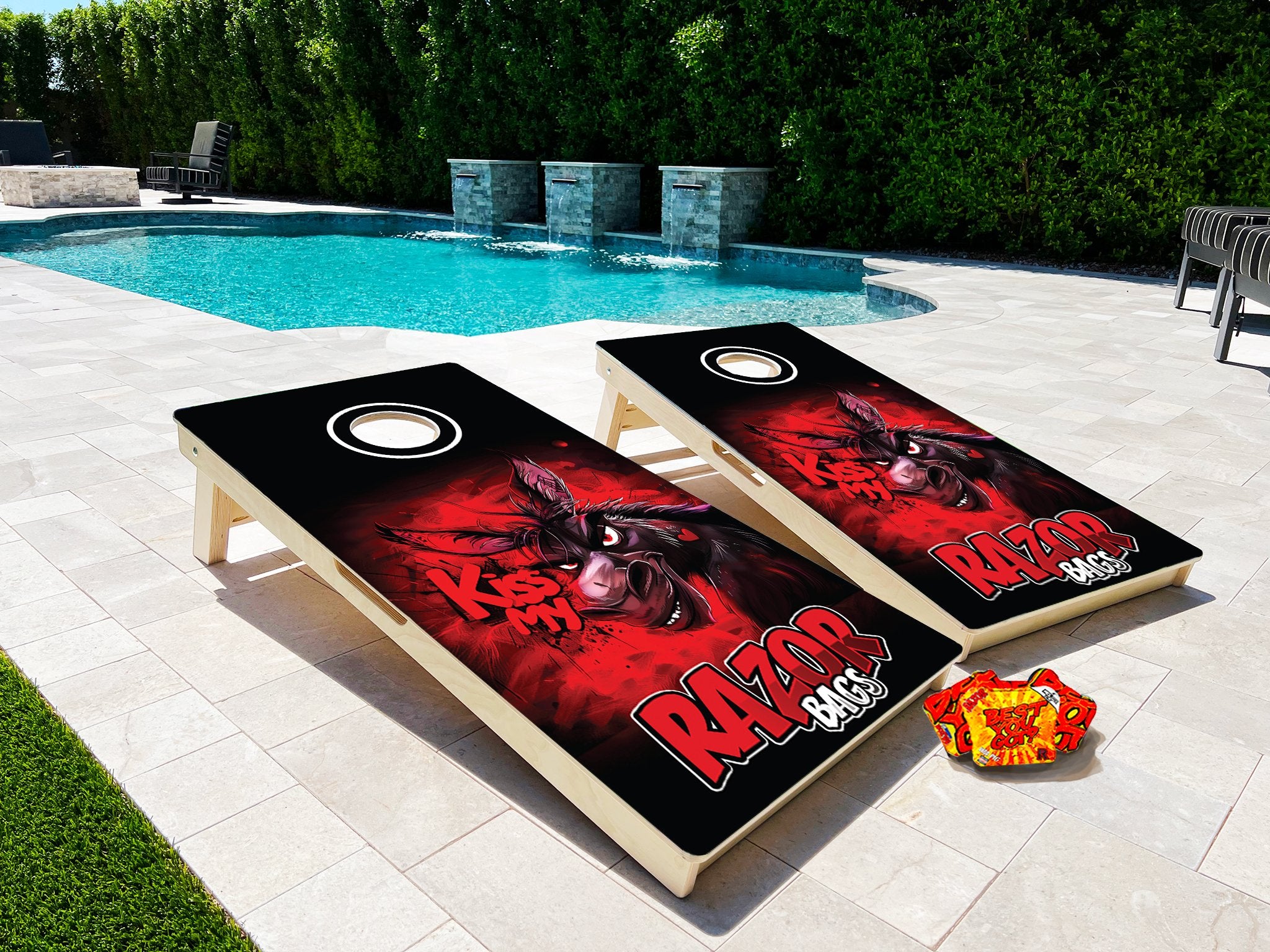 2 Cornhole Boards Next to a Pool on a Patio Razor Bags on the ground