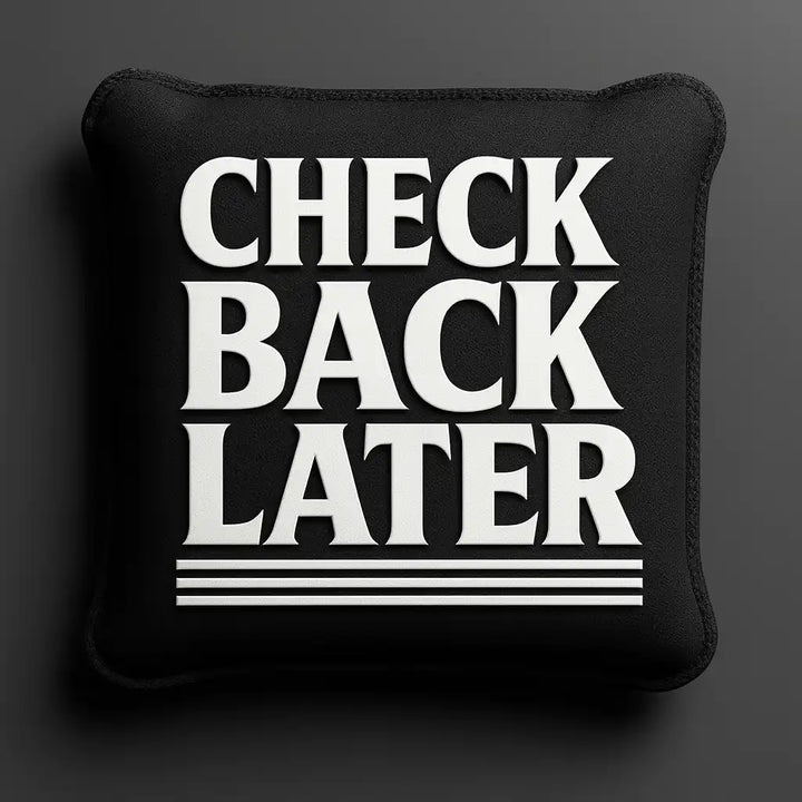 Cornhole bag with 'CHECK BACK LATER' text on a dark background