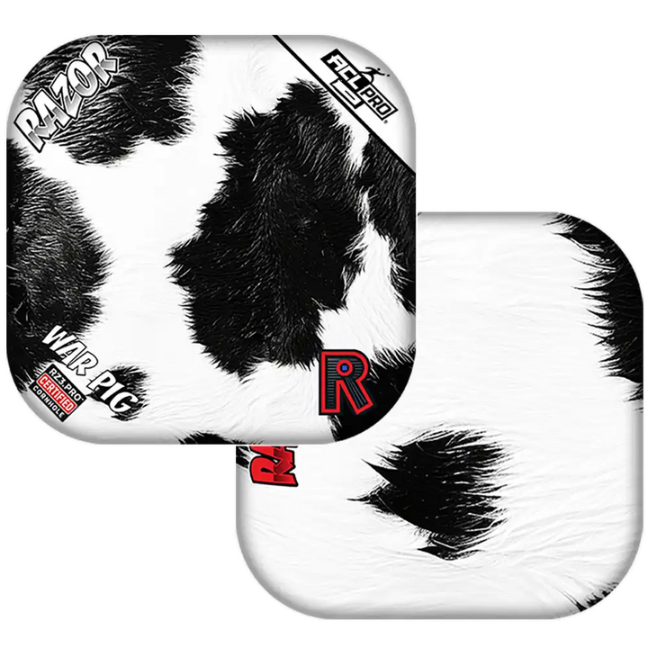 Black and white cow print Cornhole bags with 'Razor' branding on a white background