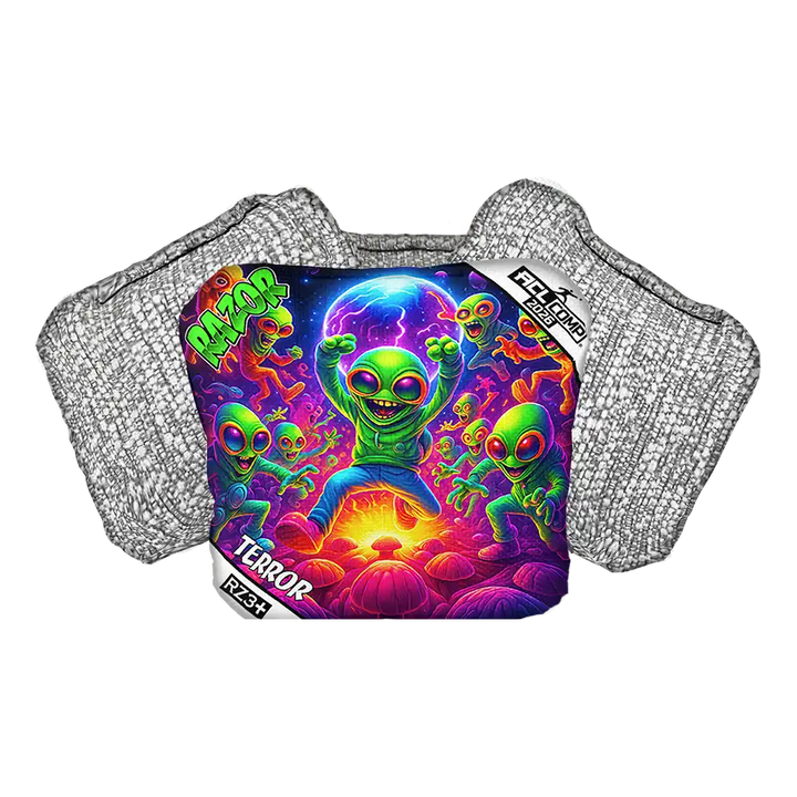 Cornhole bag with colorful alien design on a protective pad with 'Razor' branding.