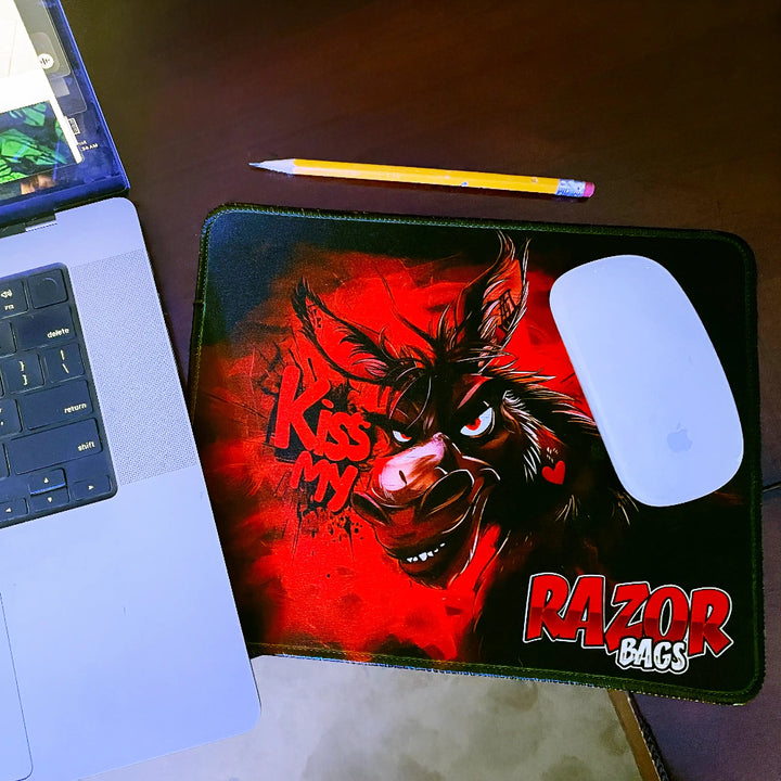 Laptop with a mouse on a mouse pad featuring a donkey design and 'Razor Bags' branding.