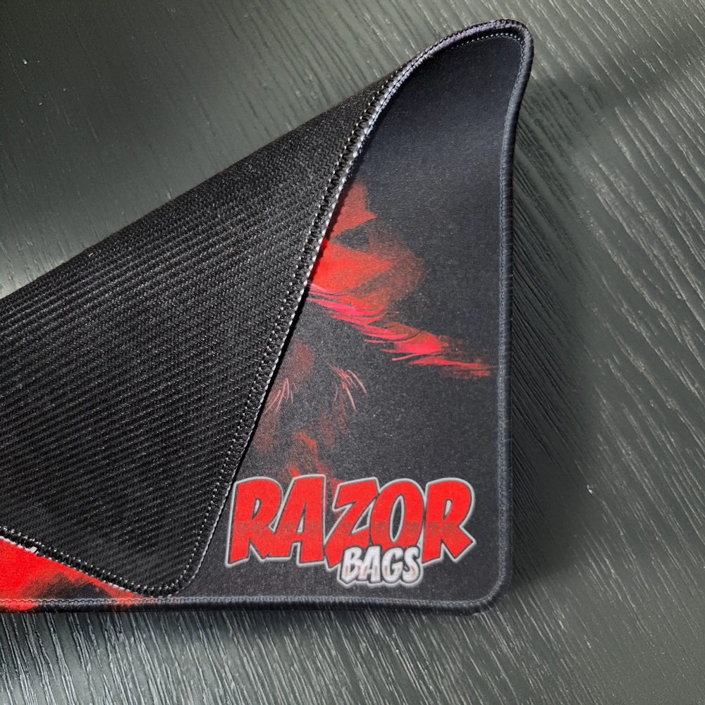 Black mousepad with red and white design featuring 'RAZOR BAGS' on a textured gray background